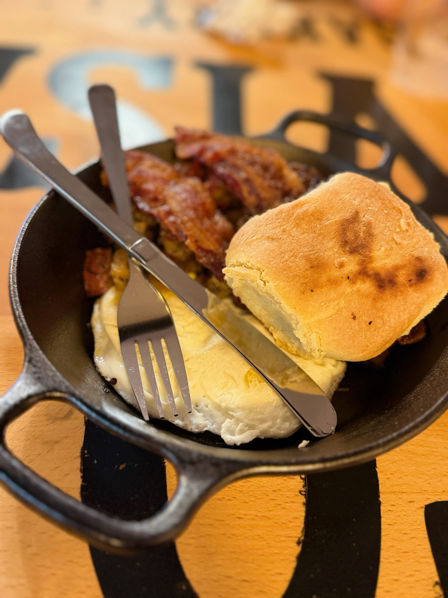 Skillet breakfast with eggs, bacon, and a biscuit