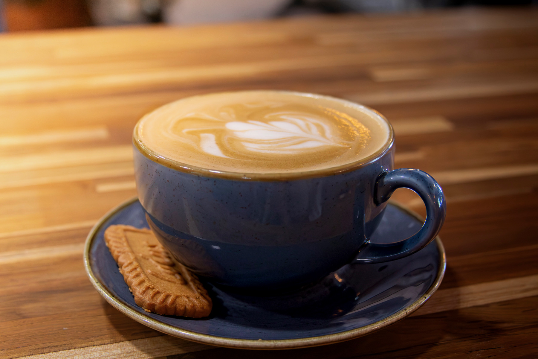 A latte with a cookie at Benco Provisions